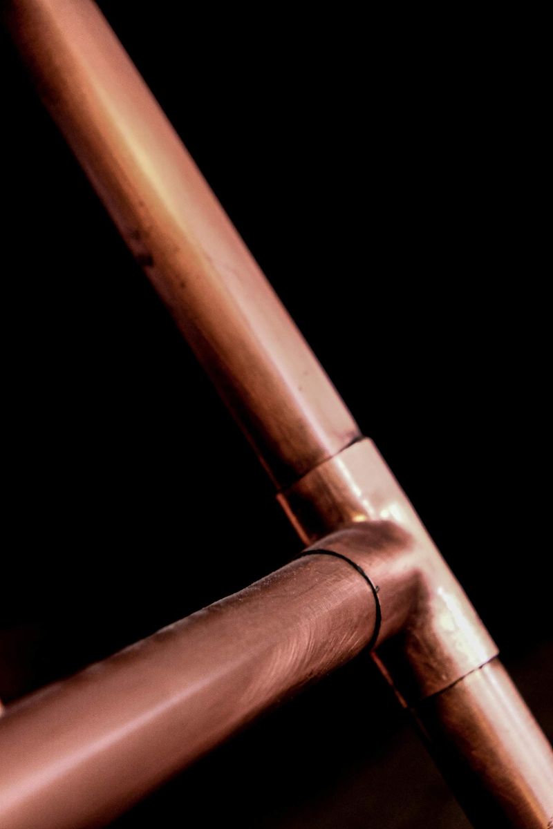 Close-up of a soldered copper pipe joint